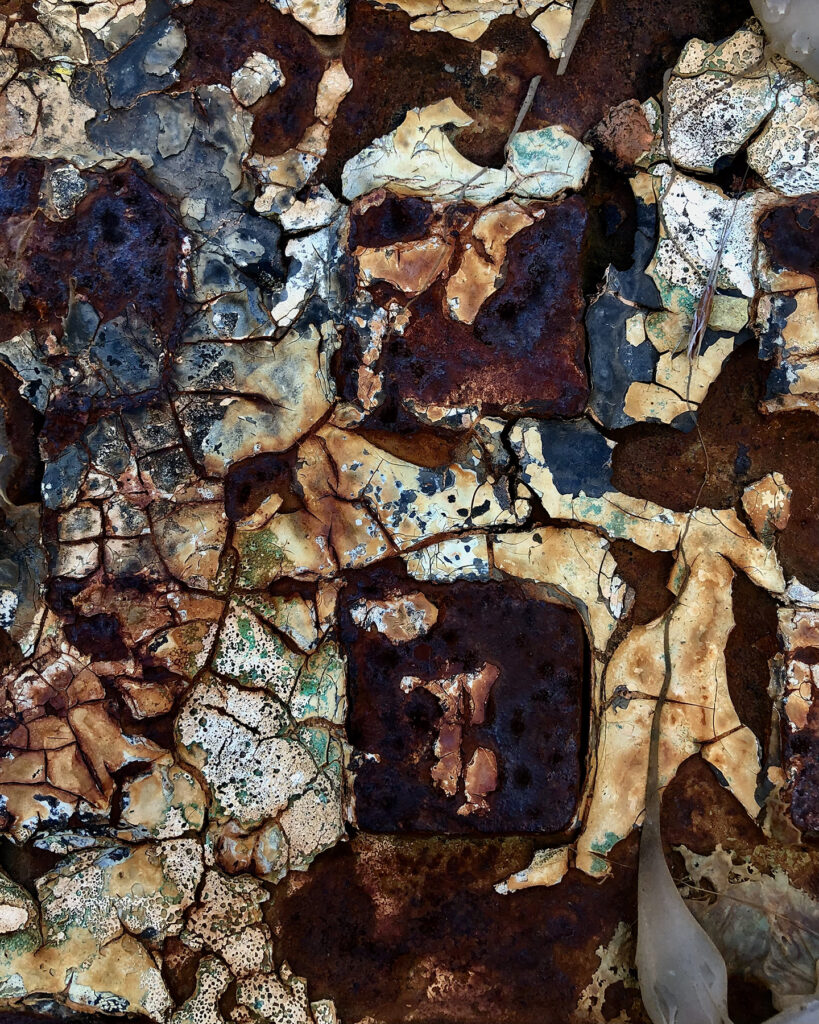 A close-up of a textured pattern of gray, brown and blue tones.